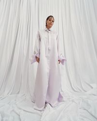 A daring pearl white gown with an androgynous air and bold bow sleeves, designed for the avant-garde bride. A sustainable wedding collection designed in Vienna, that redefines modern bridal fashion with its striking, minimalist aesthetic.