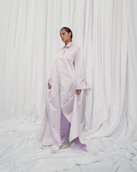 A daring pearl white gown with an androgynous air and bold bow sleeves, designed for the avant-garde bride. A sustainable wedding collection designed in Vienna, that redefines modern bridal fashion with its striking, minimalist aesthetic.