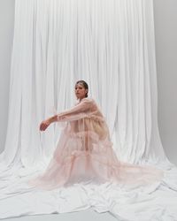 A daring pastel pink gown with sheer, flowing layers and bold ruffle accents, designed for the modern bride. A sustainable wedding collection designed in Vienna, that redefines modern bridal fashion with its striking, minimalist aesthetic.